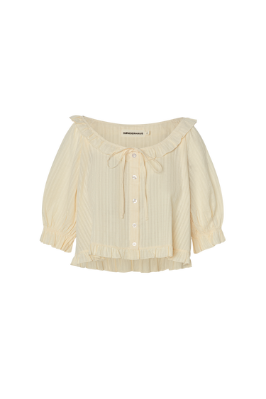 Cream eyelet, button-up blouse with a ruffled neckline and short sleeves on a white background.