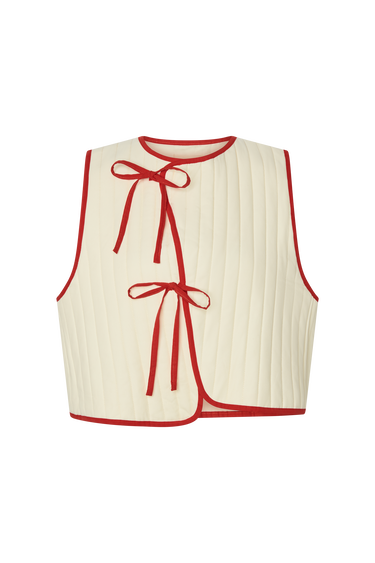 Cream sleeveless top with red trim and ribbed texture on a white background.