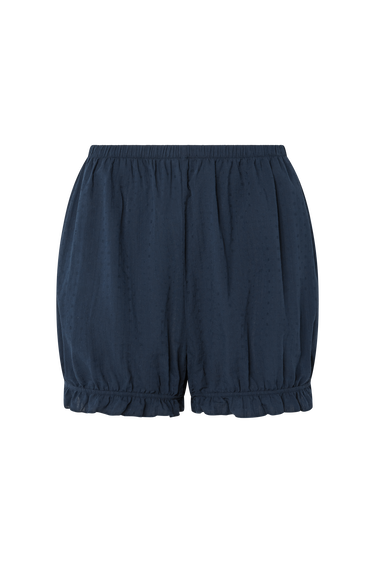 Navy blue eyelet, bloomer-style shorts with ruffled hem on a white background.