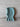 Teal ribbed balaclava on a light gray surface