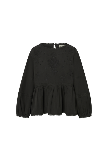 Black eyelet long sleeve blouse with peplum bottom on a white background.