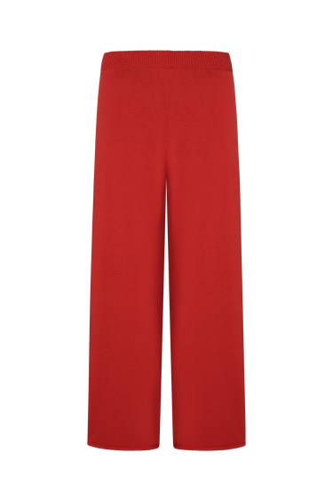 Red knit sweater pants on a white background.