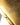 Close-up of a gold object with engraved text on a blurred background