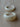 Two white ceramic rings on a beige surface