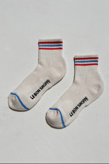 Pair of socks with red, white, and blue stripes on a light gray background