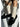 White patterned socks worn with black loafers on a light background