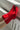 Red socks being worn on a white radiator