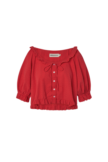 Red eyelet, button-up blouse with a ruffled neckline and short sleeves on a white background.