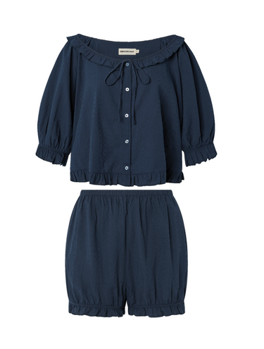 Navy blue eyelet, button-up blouse with a ruffled neckline and matching bloomer-style shorts set on a white background.