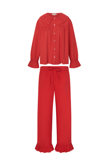 Red long sleeve blouse with a ruffled collar and matching pants with a ruffled hem on a white background.