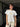 Woman wearing a white t-shirt with a pear graphic and pinstripe pants.