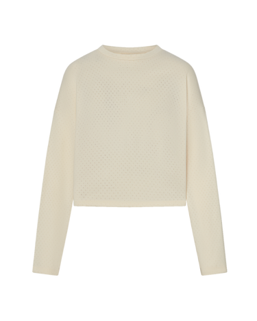 Cream long sleeve top with pointelle details on a white background.