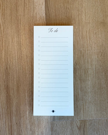 To-do list notepad on a wooden surface