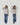 Before and after comparison of a woman wearing a light gray shirt and blue jeans on a white background.