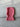 Pink knitted dog hood on a gray surface