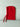 Red knitted bonnet on a light gray background