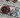 Two scrunchies, one purple and one light blue, on a lace tablecloth.