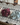 Two scrunchies, one purple and one light blue, on a lace tablecloth.