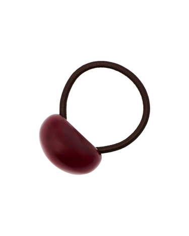 Brown hair tie with a red resin accent on a white background