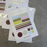 Color swatch cards on a concrete surface