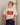 Woman wearing a cream t-shirt with a red sardine tin graphic that says "Sønderhaus Sardines", paired with denim pants.
