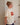 Woman wearing a cream t-shirt with a red sardine tin graphic that says "Sønderhaus Sardines".
