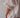 Close-up image of a woman wearing a white, bloomer-style shorts and a matching flowy, feminine top.