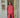 Woman standing in a doorway and holding a mug, wearing a red blouse and pants set.