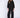 Woman wearing a black, rolled hem sweater and matching black sweater pants on a white fabric background.