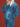 Person wearing a blue denim jacket against a red background