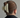 Person wearing a large matte cream hair clip on a plain background