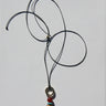 Necklace with beads on a light gray background