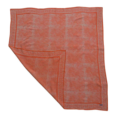 Orange patterned fabric on a white background