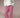 Woman wearing a white cable knit sweater and red gingham pants on a beige background