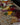 Assorted food platter with bread, cheese, fruits, and meats on a table.