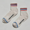 Pair of socks with red, white, and blue stripes on a light gray background