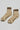 Beige socks with brown stripes and 'Le Bon Shoppe' branding on a light gray background