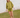 Woman wearing a green knit matching sweater and shorts set standing outdoors with a white wooden structure in the background.