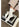 White socks with a subtle pattern worn by a person on a stack of books.