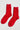 Pair of red socks on a light gray background