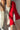 Red and beige patterned socks on a neutral background