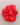 Red flower-like fabric item on a light gray background