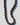 Necklace with brown and blue beads on a white background