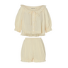 Cream eyelet, button-up blouse with a ruffled neckline and matching bloomer-style shorts set on a white background.