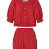Red eyelet, button-up blouse with a ruffled neckline and matching bloomer-style shorts set on a white background.