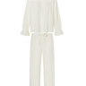 White long sleeve blouse with a ruffled collar and matching pants with a ruffled hem on a white background.