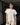 Woman wearing a white t-shirt with a pear graphic and pinstripe pants.