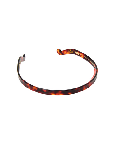 Tortiseshell thin headband on a white background.