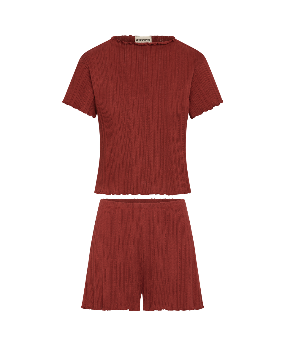 Red ribbed top and shorts set on a white background
